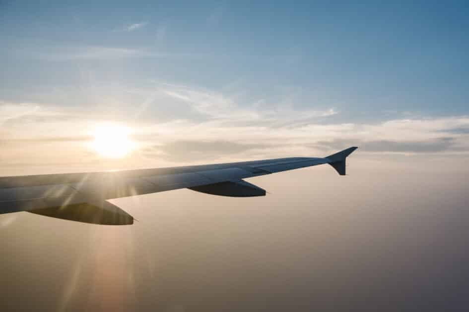 Master of Science in Travel Management (Academic Track) airplane wing and sunset on blue sky