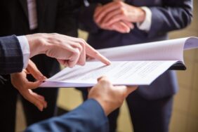 cropped-view-businesswomen-reading-document-min